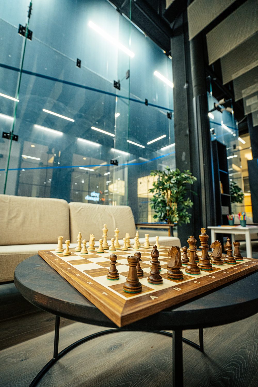 Lounge area with chess board overlooking the squash court
